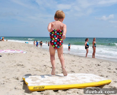 Bethany Beach Bliss: A Delaware Getaway 15 Clara jumping off a boogie board onto the sand with enthusiasm.