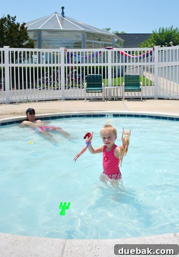 Bethany Beach Bliss: A Delaware Getaway 20 Clara happily playing in a shallow baby pool.