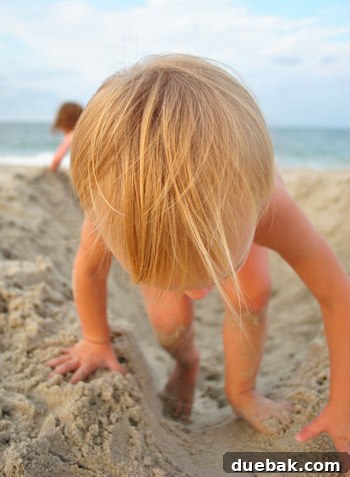 Bethany Beach Bliss: A Delaware Getaway 30 Clara's blonde hair shining in the sun while playing on the beach.