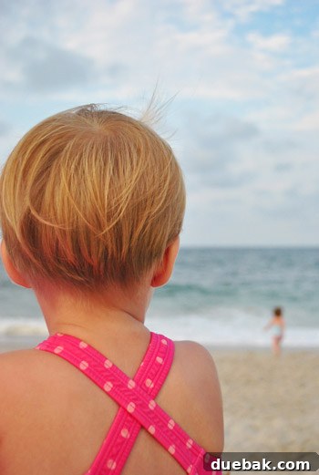 Bethany Beach Bliss: A Delaware Getaway 31 Clara's recent haircut, showing shorter hair, while she plays in the sand.
