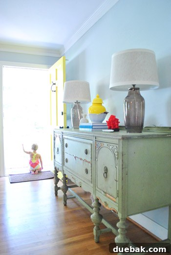 Elevate Your Dining Buffet Decor 13 Clara kneeling and waving at the front door