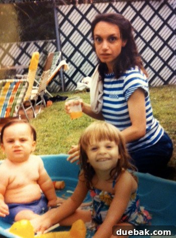 Love's Tender Tears 4 A young woman smiling in a pool, holding a young girl and boy.