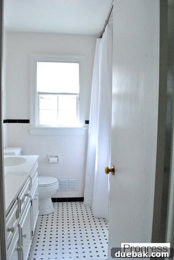 Listy McListerson Refreshed 7 Our hall bathroom with a new light fixture and high-hung shower curtain, awaiting further renovation and personalization.