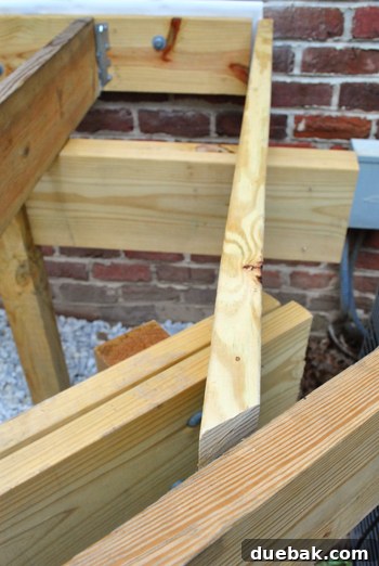 Laying the Groundwork for Your Deck 13 A newly cut 2x8 board with a mitered end, test-fitted for the deck's open edge