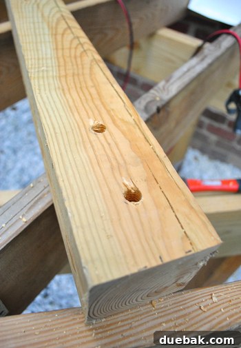 Laying the Groundwork for Your Deck 28 Drilling holes into a 4x4 guard rail post for tension tie attachment