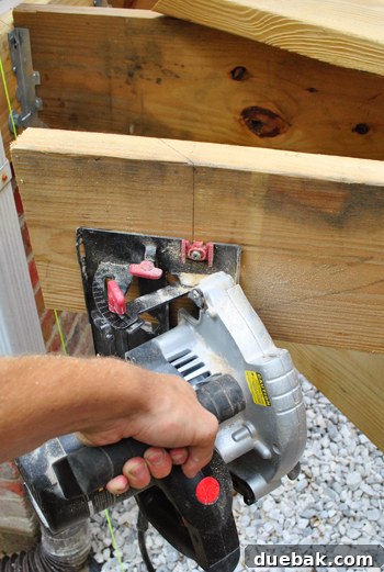 Laying the Groundwork for Your Deck 8 Performing an angled cut on a deck joist with a circular saw (staged for photo)