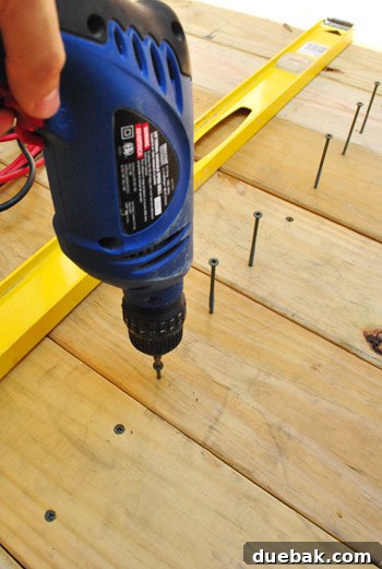 The Foundation of Your Deck 21 Close-up of the screws being driven into the deck boards, highlighting the challenges with standard heads.