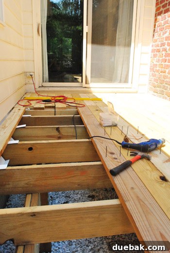 The Foundation of Your Deck 22 The author checking the cupping direction of a deck board before installation.