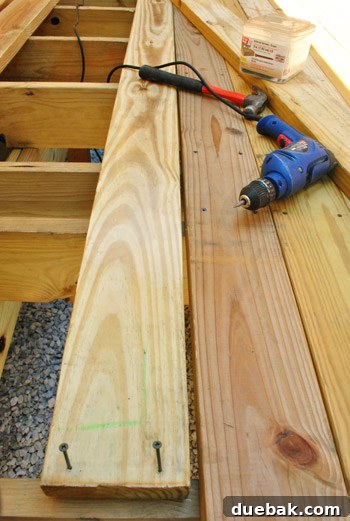 The Foundation of Your Deck 23 Warped deck board exhibiting a significant gap at one end, illustrating a common installation challenge.