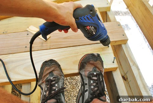 The Foundation of Your Deck 24 The author using body weight to force a warped deck board into position against another.