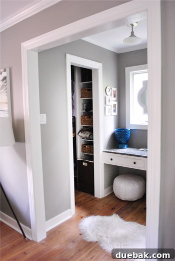 Unorganized closet before makeover, revealing various baskets and clothing piles from a bed's perspective.