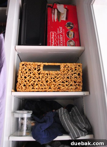 Before shot of the closet's upper shelves, showing cluttered and disorganized items.