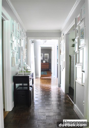 My First Home Then and Now: A Year's Perspective 11 Current house hallway, wide, bright, and featuring a large family gallery wall.