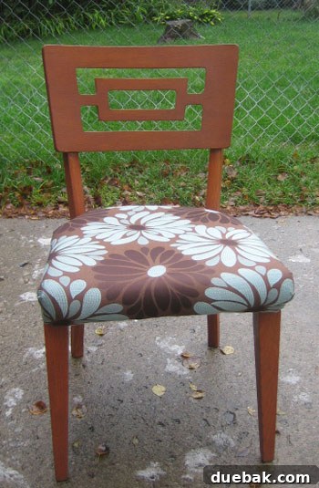 Goodwill Chair After Makeover After shot of a vintage wooden dining chair, beautifully refinished and reupholstered in a modern, elegant fabric.