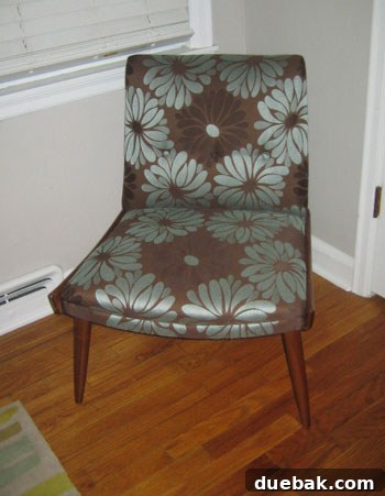 eBay Armchair After Makeover After shot of a vintage armchair, professionally reupholstered in an elegant fabric, showcasing a complete and luxurious transformation.