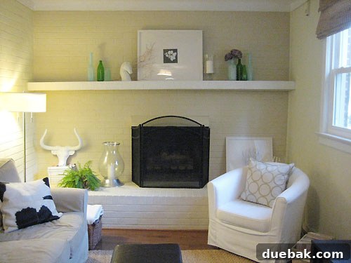 accessorizing-your-fireplace Fireplace mantel with blue vases and green bottles