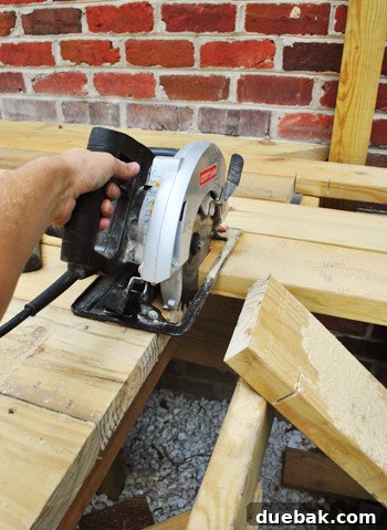 Crafting Your Perfect Outdoor Deck 8 Cutting the deck boards with a circular saw.