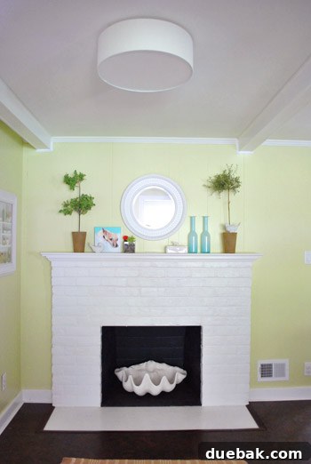 Mirroring Elegance Above the Mantel 14 Side-by-side comparison of the old small mirror and the new large mirror above the fireplace.