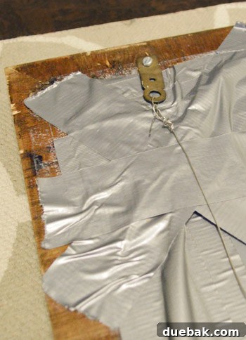 Mirroring Elegance Above the Mantel 7 Another view of the mirror's back, emphasizing the duct tape and hanging mechanism.