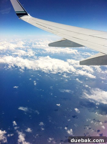 A Parent's Playbook for Flying with Toddlers 2 airplane wing over ocean with clouds