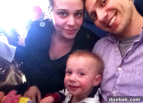 A Parent's Playbook for Flying with Toddlers 3 family selfie on airplane with 1 year old