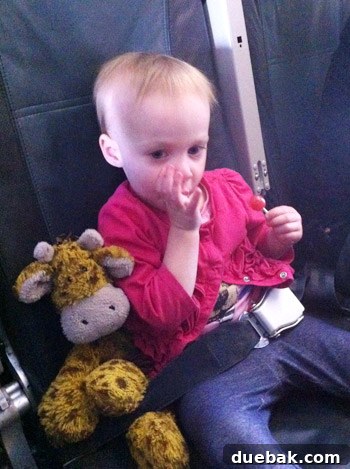 A Parent's Playbook for Flying with Toddlers 6 flying with toddler lollipop eating to help with ear popping