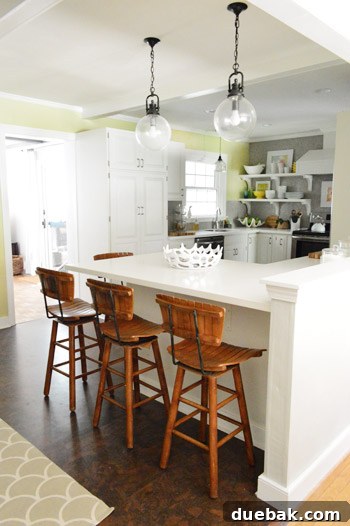 Kitchen Charm: Vintage Wood Stool Finds 9 Full view of the kitchen peninsula with the new vintage swivel stools