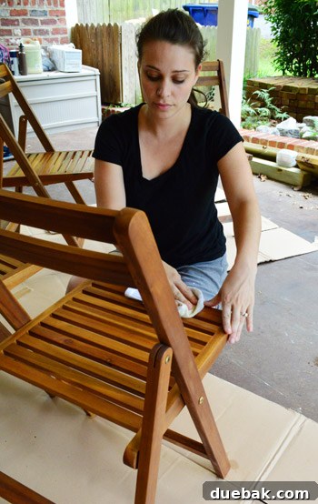 The Outdoor Furniture Secret: Varnish and Teak Oil for Enduring Beauty 9 Person diligently applying oil to outdoor chair