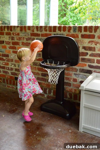 Clara playing with her newly painted 'shiny hoop' with colorful balls