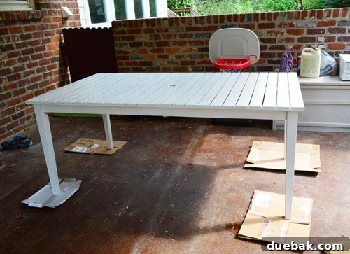 Actual photo of the bright basketball hoop partially visible behind a table