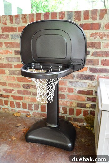 The newly painted oil-rubbed bronze basketball hoop with its white net