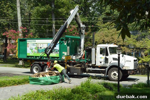 Crane hooking up to the Bagster