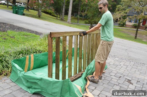 Long piece of wood being loaded into Bagster