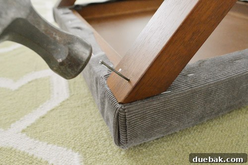 Drilling pilot holes and attaching upholstered tops to table legs with nails