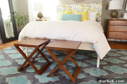 Side tables placed in front of a bed before conversion, assessing fit