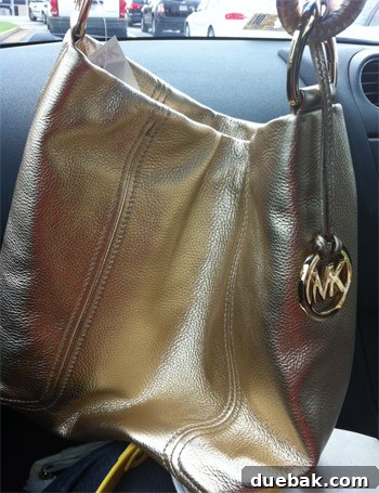 Woman showing off her new, high-quality handbag