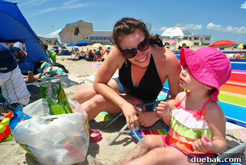 Woman enjoying a beach day in a flattering V-neck swimsuit