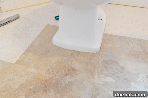 Vinyl tile perfectly cut around the toilet
