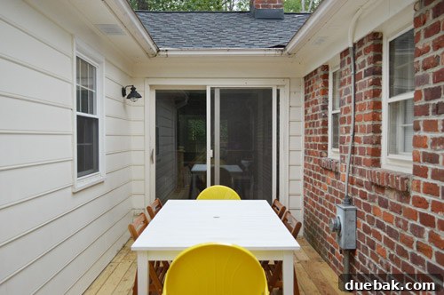 The old sliding door's exterior rear view, highlighting its previous condition and lack of aesthetic appeal.