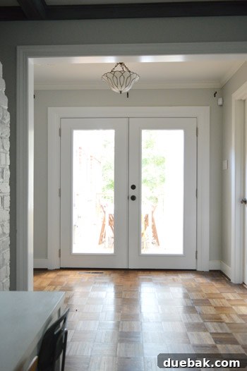 Full view of the stunning new French doors, painted white, enhancing the interior decor and brightness.