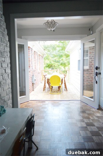 Both French doors fully open, creating a wide, inviting passage to the outdoors, enhancing light and space.