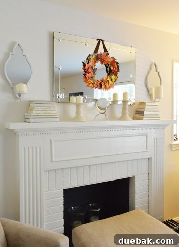 Newly installed candle sconces flanking a mirror over a fireplace mantel.