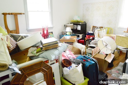Extremely cluttered playroom before organization
