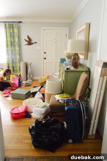 Entryway filled with sorted items, including mom organizing