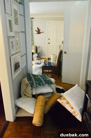 Entryway and hallway with a large pile of pillows for yard sale