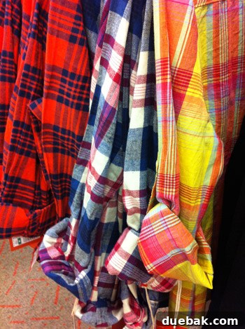 Colorful boys' shirts displayed with rolled sleeves, showcasing vibrant kids' fashion