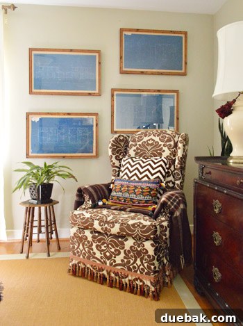 Upstairs bedroom with patterned fabric, wood accents, and uniquely offset framed blueprints from West Elm
