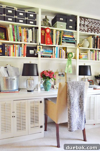 Lesley's basement office with black storage, stylish lamps, casual stacks of books, and a cozy, lived-in feel