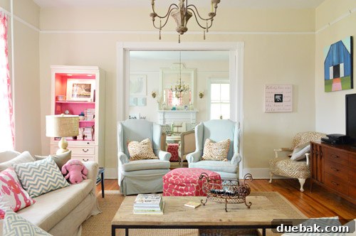 Farmhouse Drifters A Happy Country Home 4 Colorful Traditional Farmhouse Living Room With Wingback Chairs And Pink Bookcase