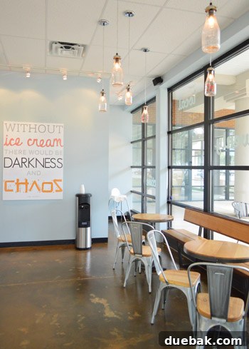 Gelati Celesti: The Store Overload Phenomenon 7 Dining area with industrial metal and wood tables, black-trimmed windows
